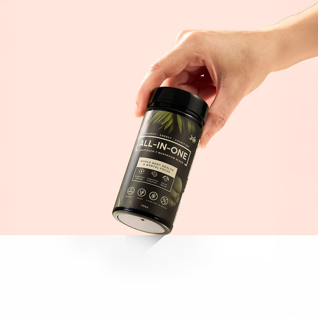 Hand holding Jaje All-In-One Adaptogen-7 Mushroom Blend for focus and energy