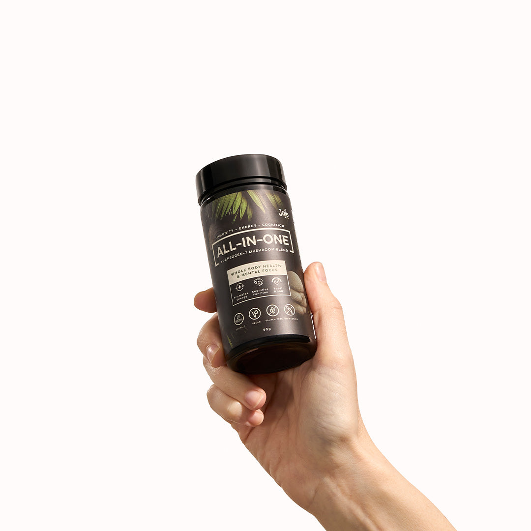 Hand holding Jaje All-In-One Adaptogen-7 Mushroom Blend for focus and energy.